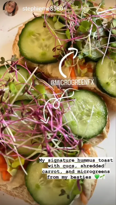 Hummus toast with cucumber, shredded carrot, and microgreens
