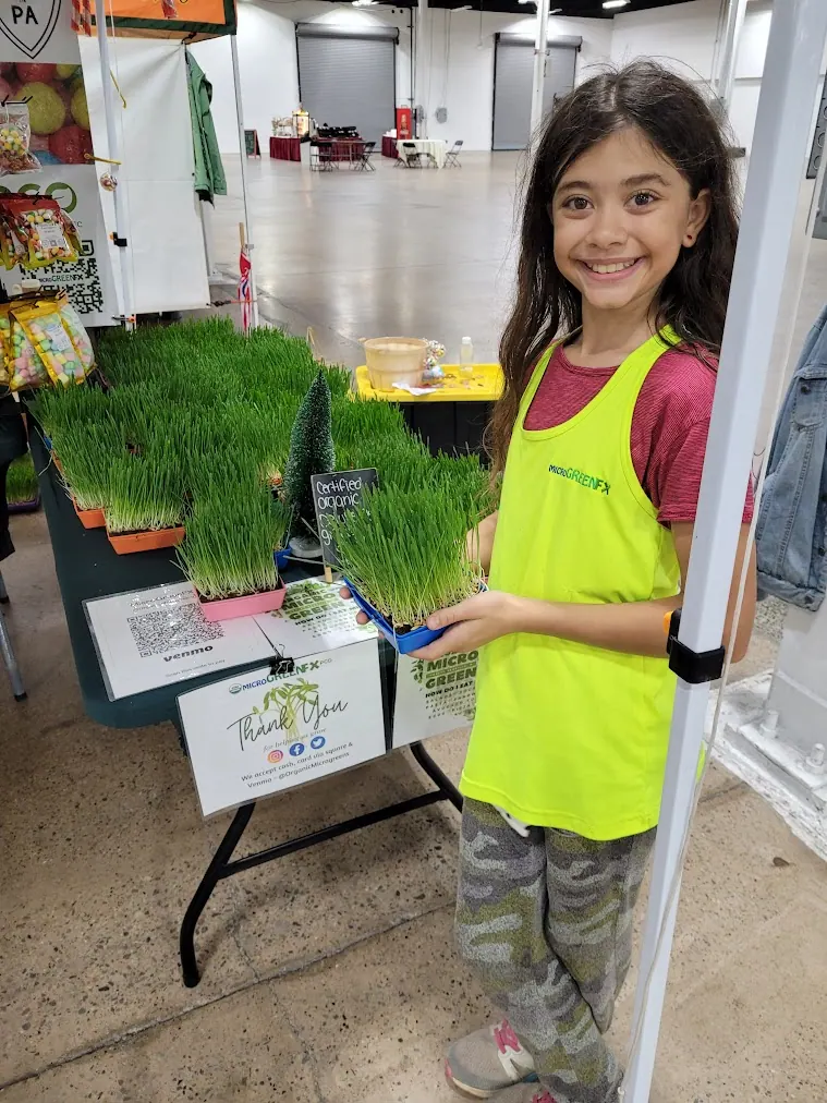 Fiona holding a tray of organic deluxe pet grass from microGREEN FX
